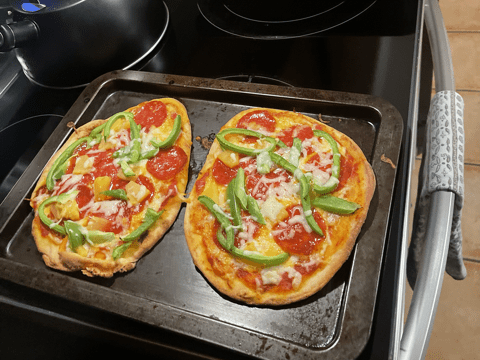 Naan Pizza with Green Peppers, Pepperoni, and an assortment of cheese.